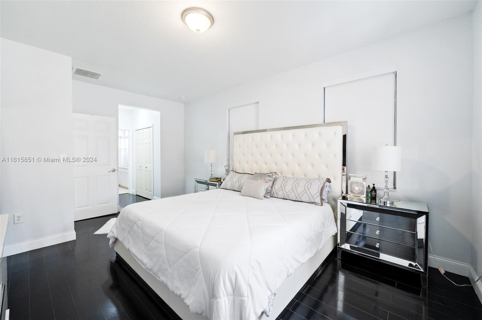 24044 Southwest 107th Court Homestead, FL 33032 - Photo 13 of 26 a bedroom with a bed and a night stand