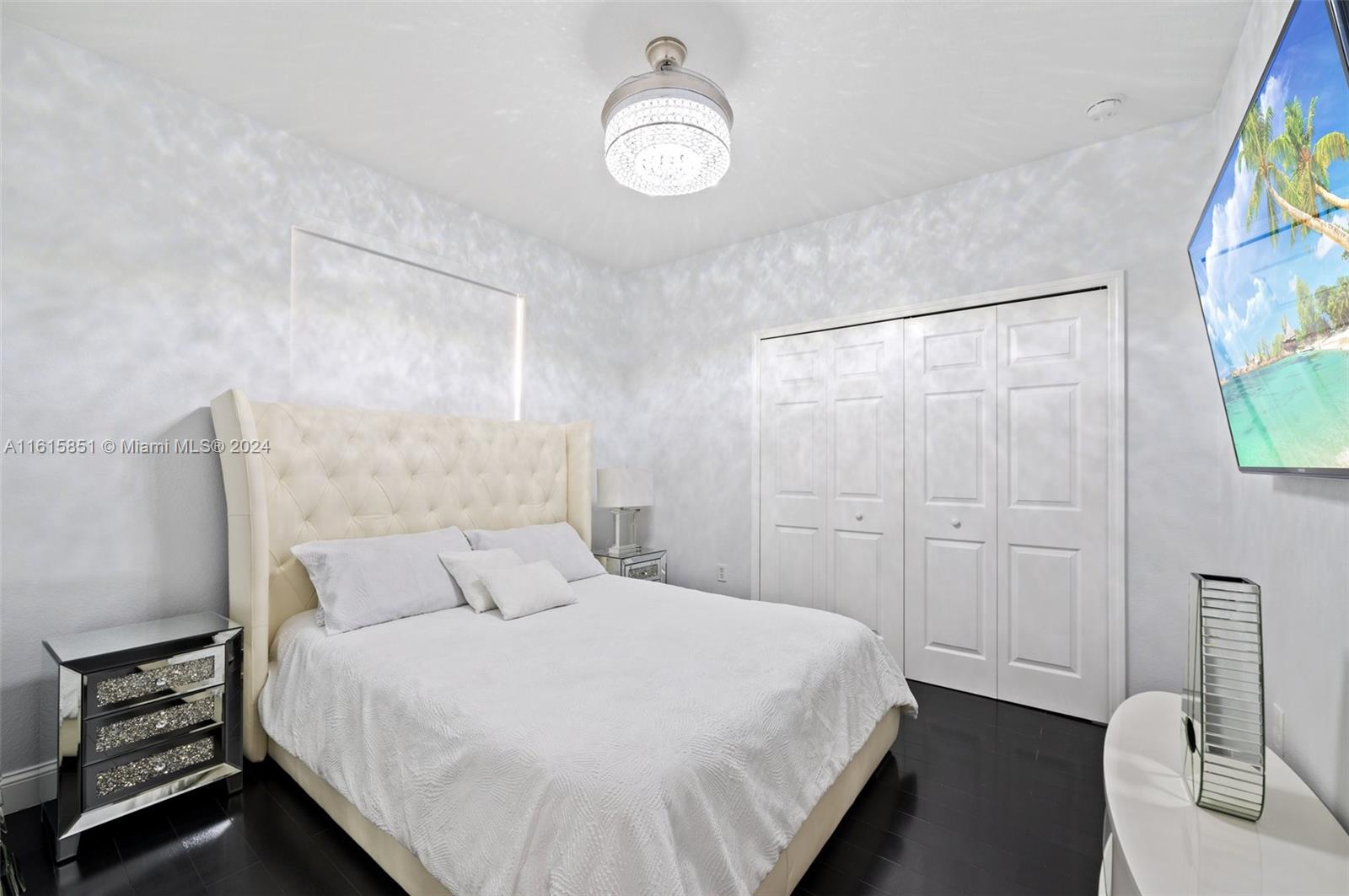 24044 Southwest 107th Court Homestead, FL 33032 - Photo 15 of 26 a bedroom with a bed and a painting on the wall