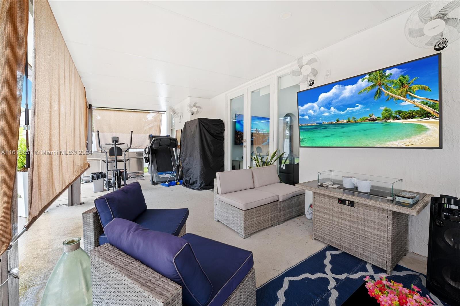 24044 Southwest 107th Court Homestead, FL 33032 - Photo 21 of 26 a living room with furniture and a flat screen tv