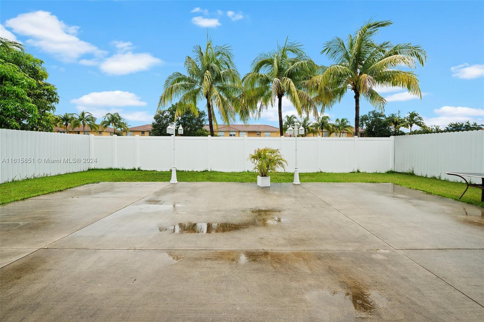 24044 Southwest 107th Court Homestead, FL 33032 - Photo 22 of 26 a view of a yard and palm trees