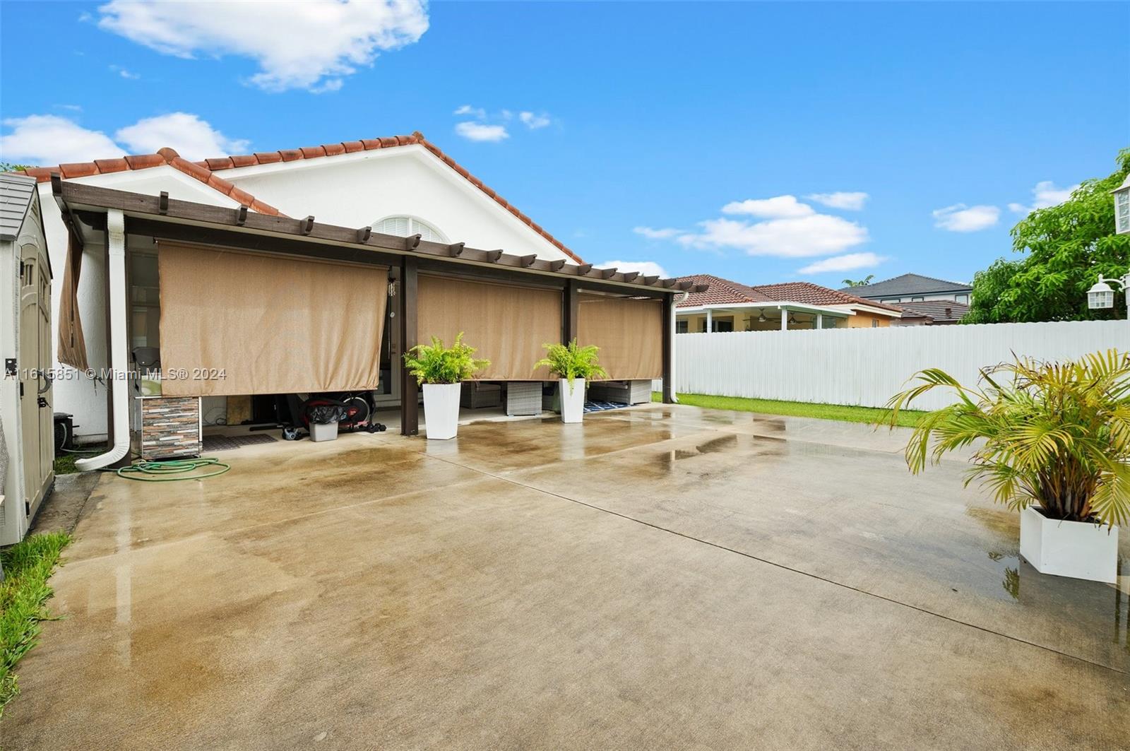 24044 Southwest 107th Court Homestead, FL 33032 - Photo 23 of 26 a house with a yard and a garage