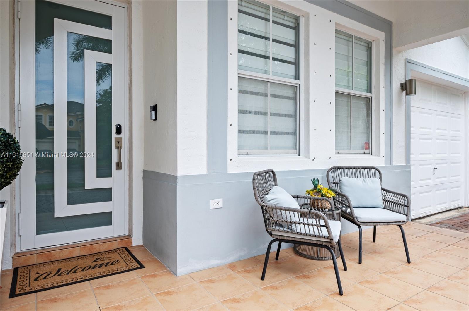 24044 Southwest 107th Court Homestead, FL 33032 - Photo 3 of 26 a patio with table and chairs