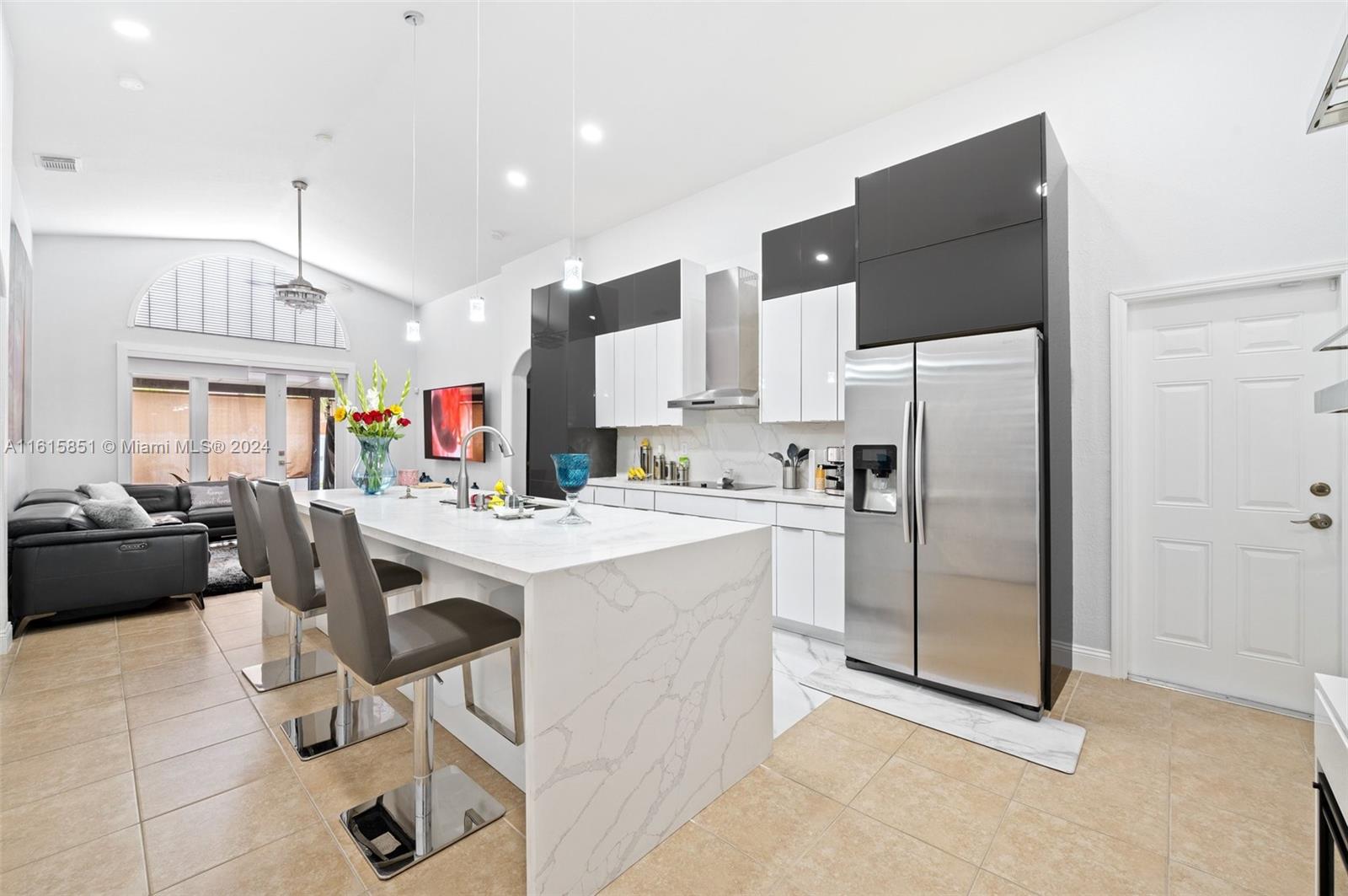 24044 Southwest 107th Court Homestead, FL 33032 - Photo 7 of 26 a kitchen that has a lot of cabinets a sink and a refrigerator