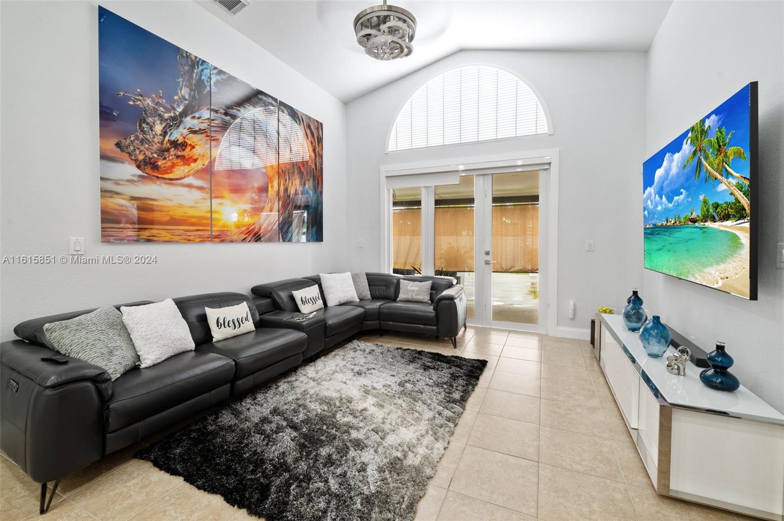 24044 Southwest 107th Court Homestead, FL 33032 - Photo 10 of 26 a living room with furniture and a flat screen tv