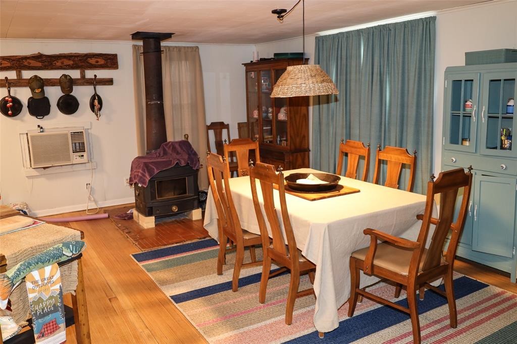 841 Dogwood Trail Logansport, LA 71049 - Photo 11 of 40 a dining room filled chandelier and wooden floor