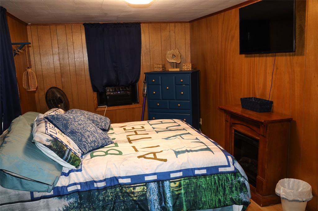841 Dogwood Trail Logansport, LA 71049 - Photo 21 of 40 a bedroom with a bed and a television