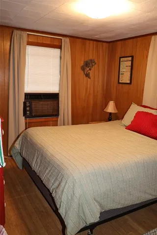 a large bed sitting in a bedroom next to a window