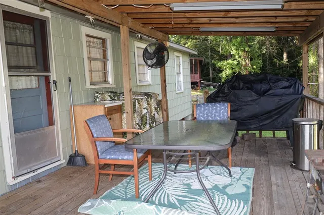 a patio with glass top table and chairs