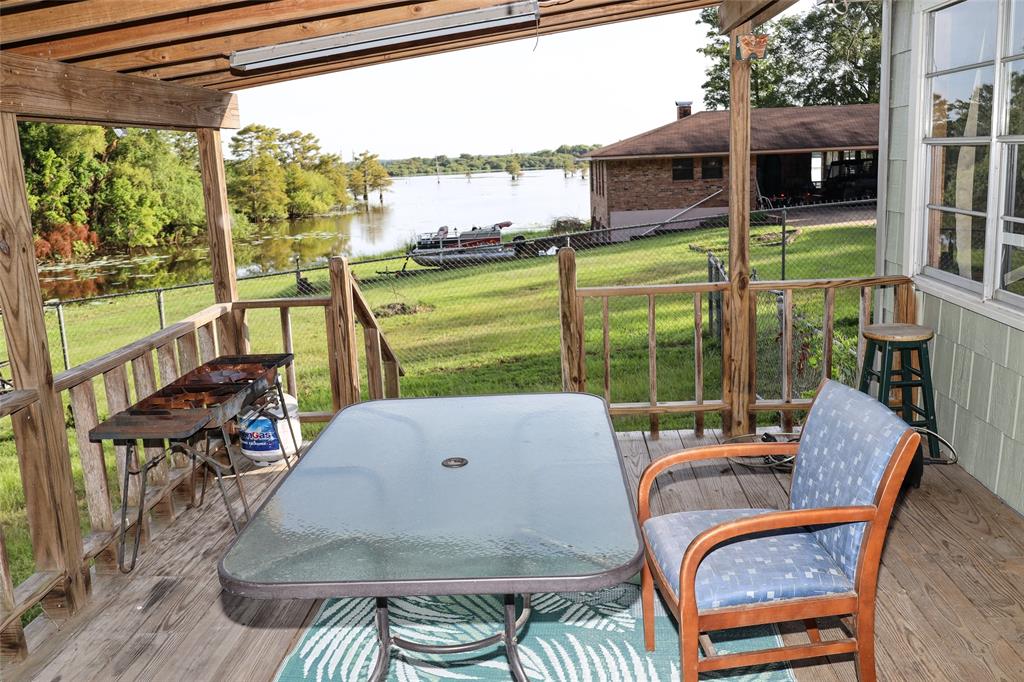 841 Dogwood Trail Logansport, LA 71049 - Photo 26 of 40 a view of a patio with table and chairs potted plants and floor to ceiling window