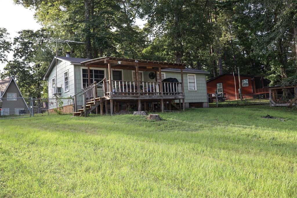 841 Dogwood Trail Logansport, LA 71049 - Photo 30 of 40 a view of a house with a backyard and a deck