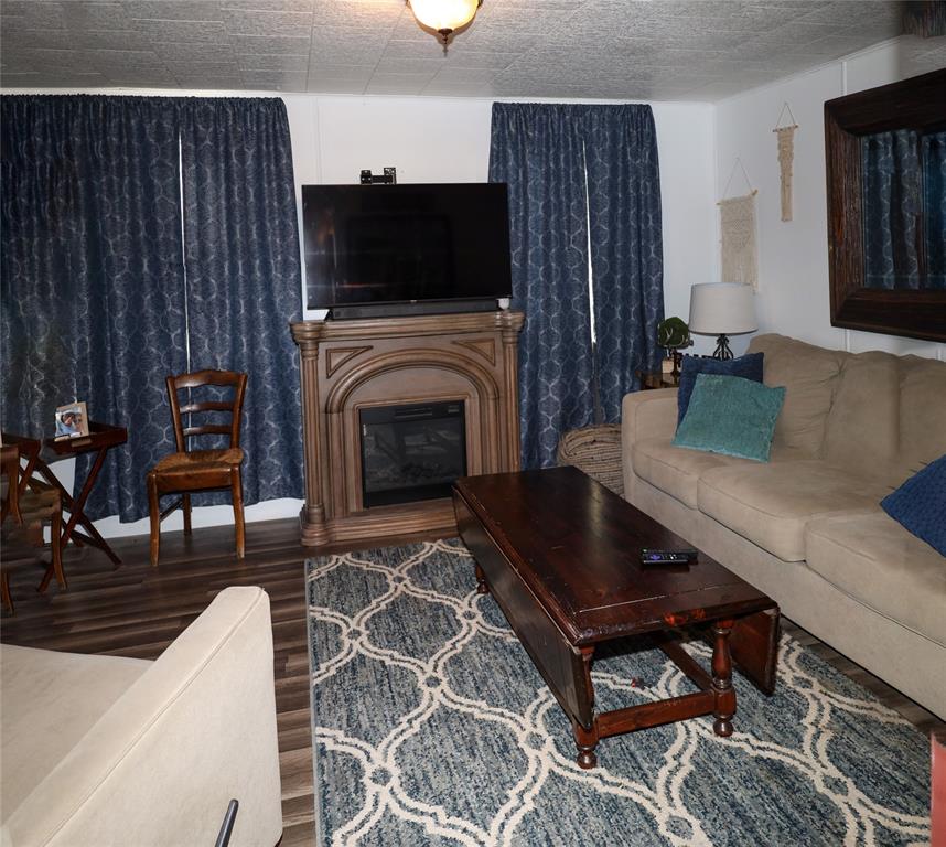841 Dogwood Trail Logansport, LA 71049 - Photo 7 of 40 a living room with furniture a flat screen tv and a fireplace