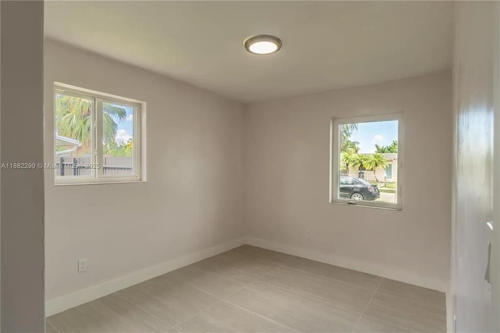 11872 Southwest 196th Terrace Miami, FL 33177 - Photo 11 of 15 an empty room with windows