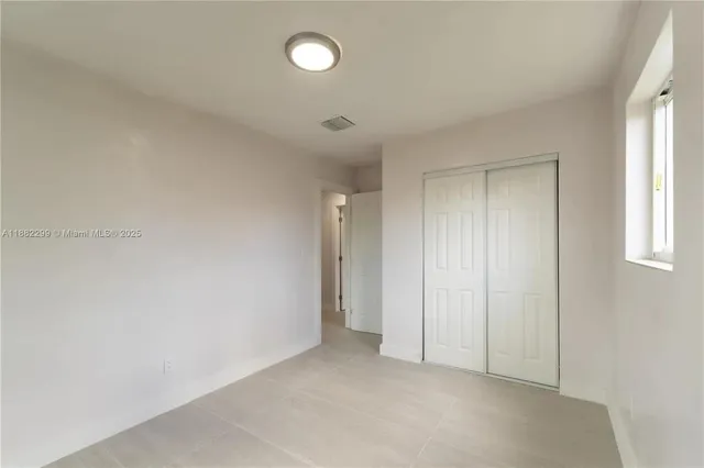 an empty room with windows and entrance