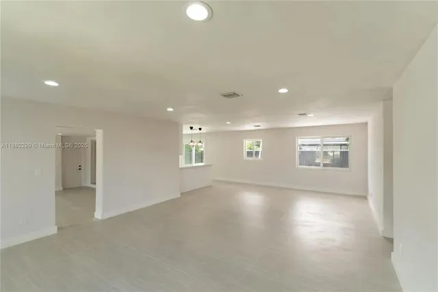 a large kitchen with a large counter top appliances and cabinets