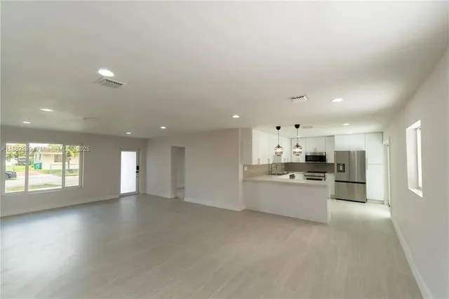 an aerial view of a house with swimming pool and outdoor seating