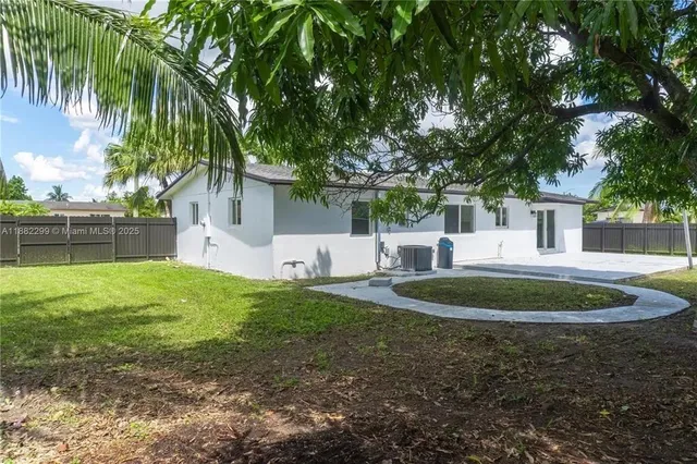 a kitchen with kitchen island a counter top space stainless steel appliances and cabinets