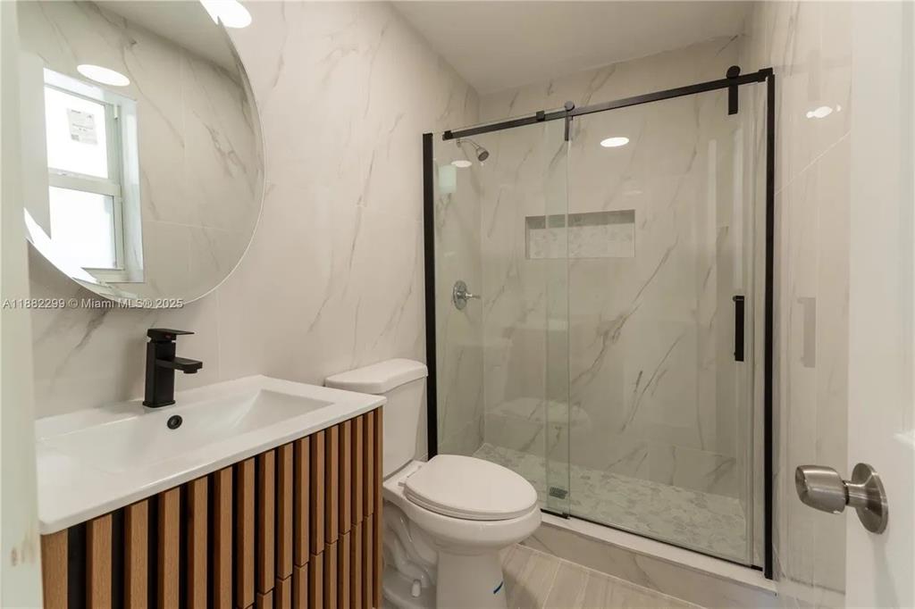 11872 Southwest 196th Terrace Miami, FL 33177 - Photo 7 of 15 a bathroom with a sink toilet and shower