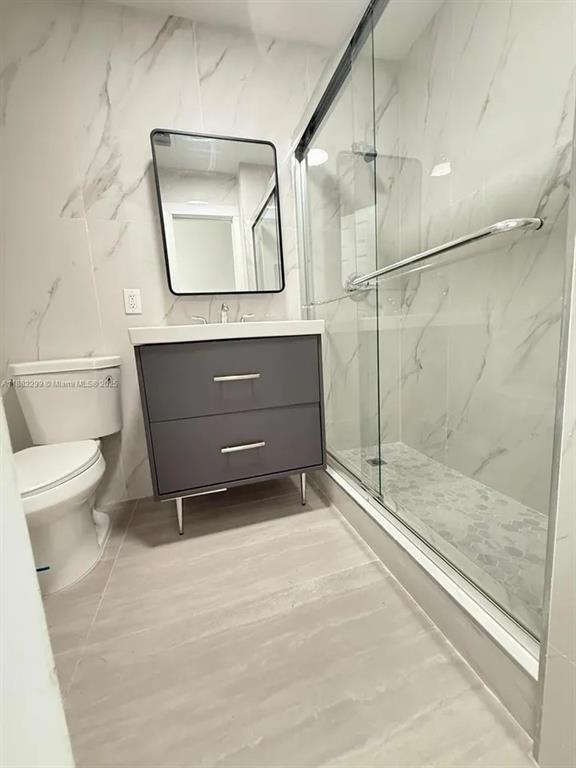 11872 Southwest 196th Terrace Miami, FL 33177 - Photo 9 of 15 a bathroom with a toilet a sink and shower