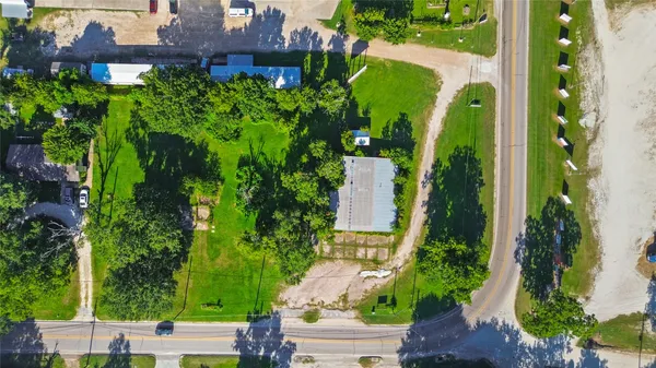 an aerial view of a house with a yard and garden