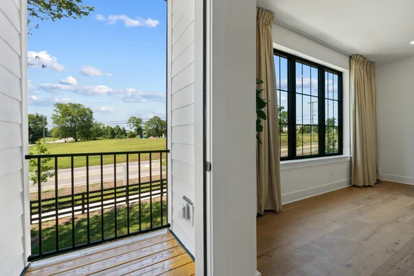 a view of a balcony with wooden floor