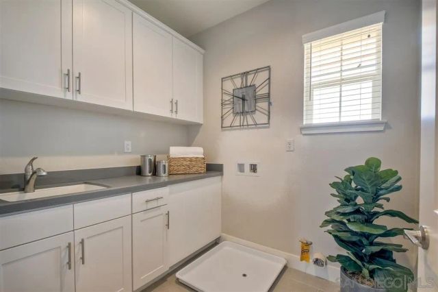 a kitchen with stainless steel appliances white cabinets and a window