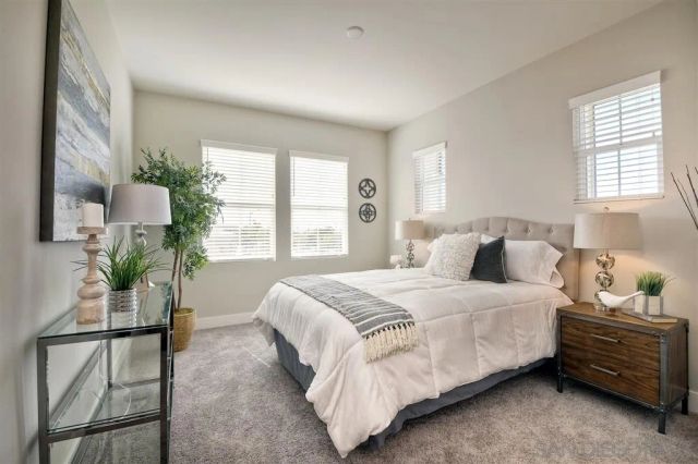 a bedroom with a bed and large window with outer view