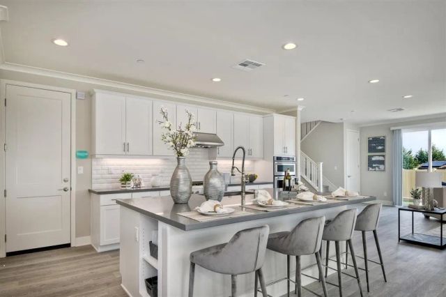 a kitchen with center island table and chairs