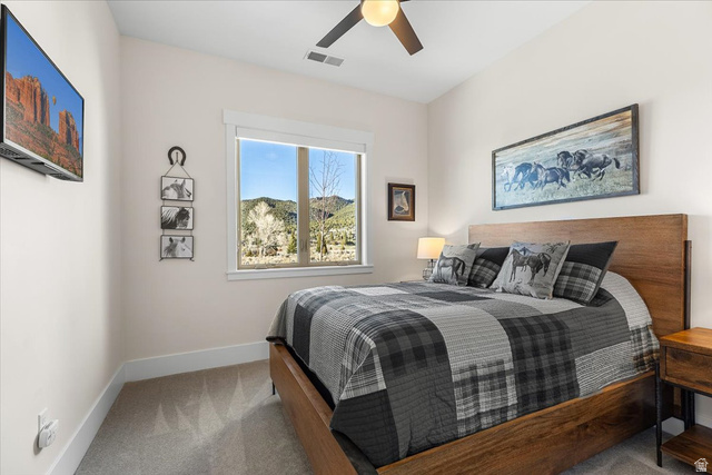 1210 East Bristle Cone Road Pine Valley, UT 84781 - Photo 18 of 54 Bedroom with light colored carpet and a ceiling fan