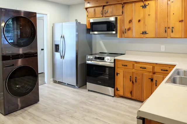 a kitchen with a stove and a refrigerator