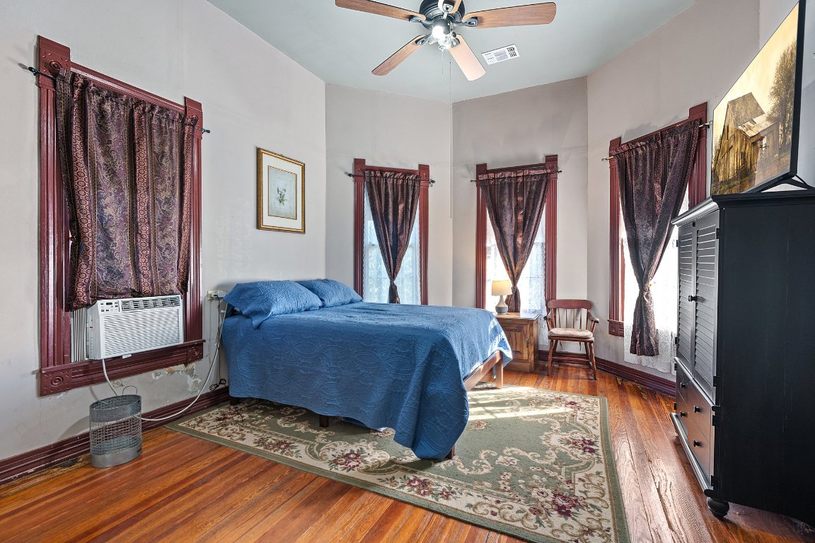 115 Fischer Store Road Fischer, TX 78623 - Photo 15 of 38 a spacious bedroom with a bed and wooden floor