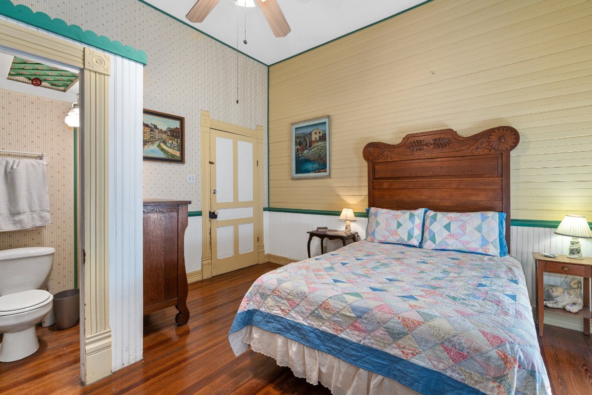 115 Fischer Store Road Fischer, TX 78623 - Photo 19 of 38 a bedroom with a bed and wooden floor