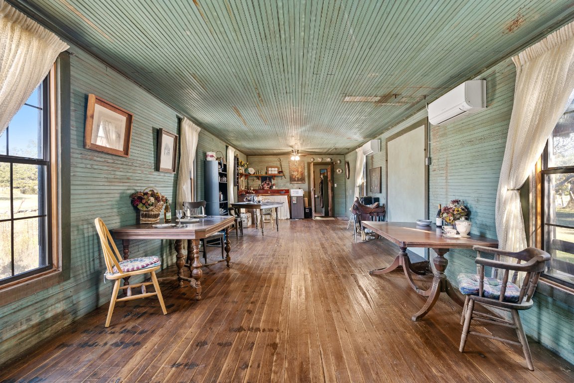 115 Fischer Store Road Fischer, TX 78623 - Photo 26 of 38 a dining room with furniture wooden floor and a rug