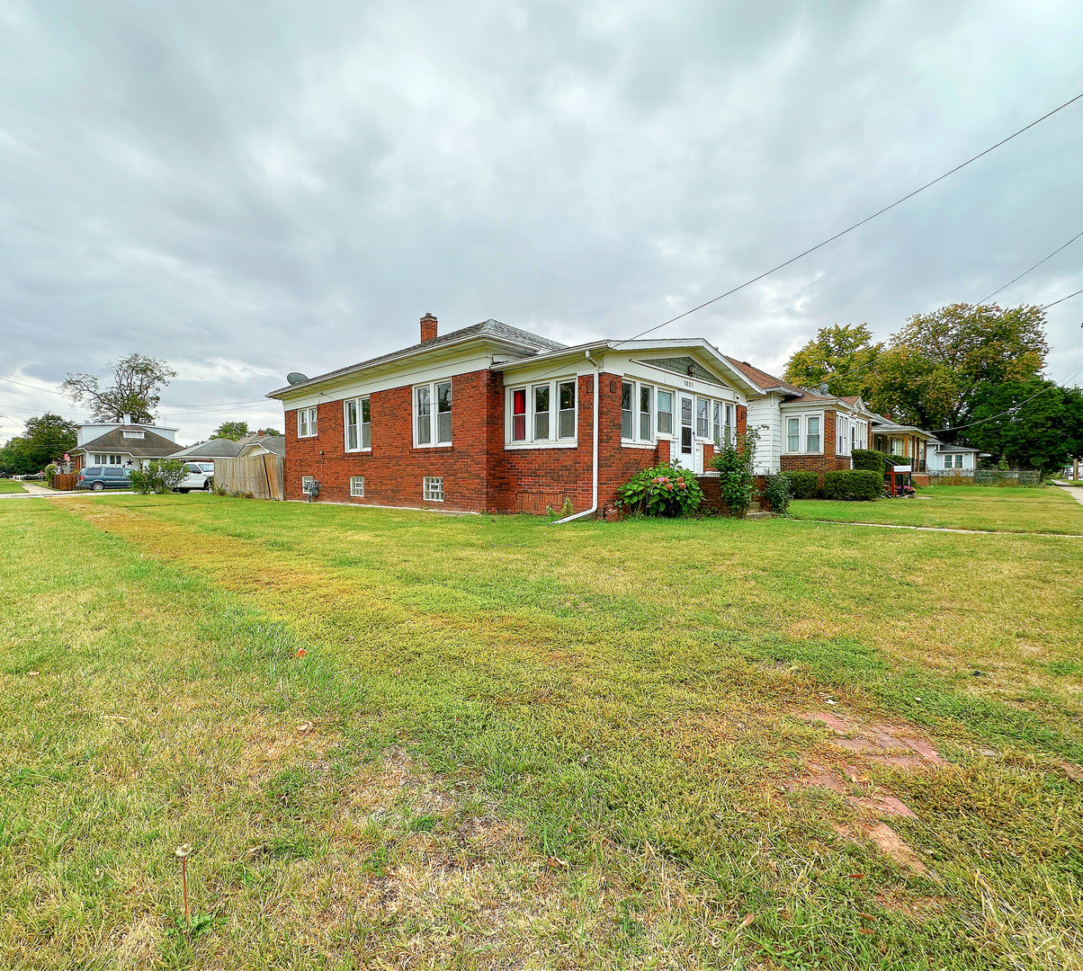 1121 East Main Street Streator, IL 61364 - Photo 18 of 22 a view of a house with a big yard and large trees