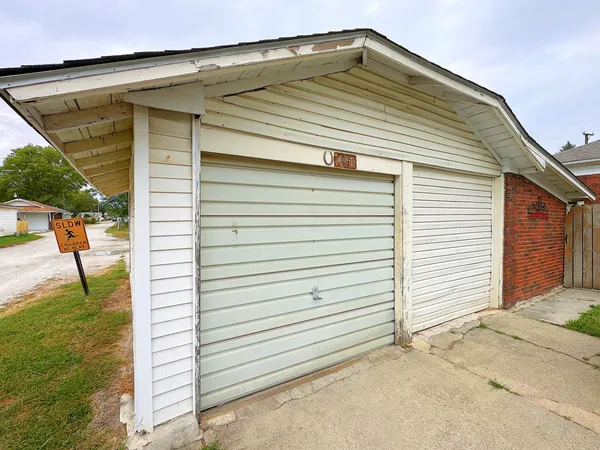 a view of garage with a table and chairs