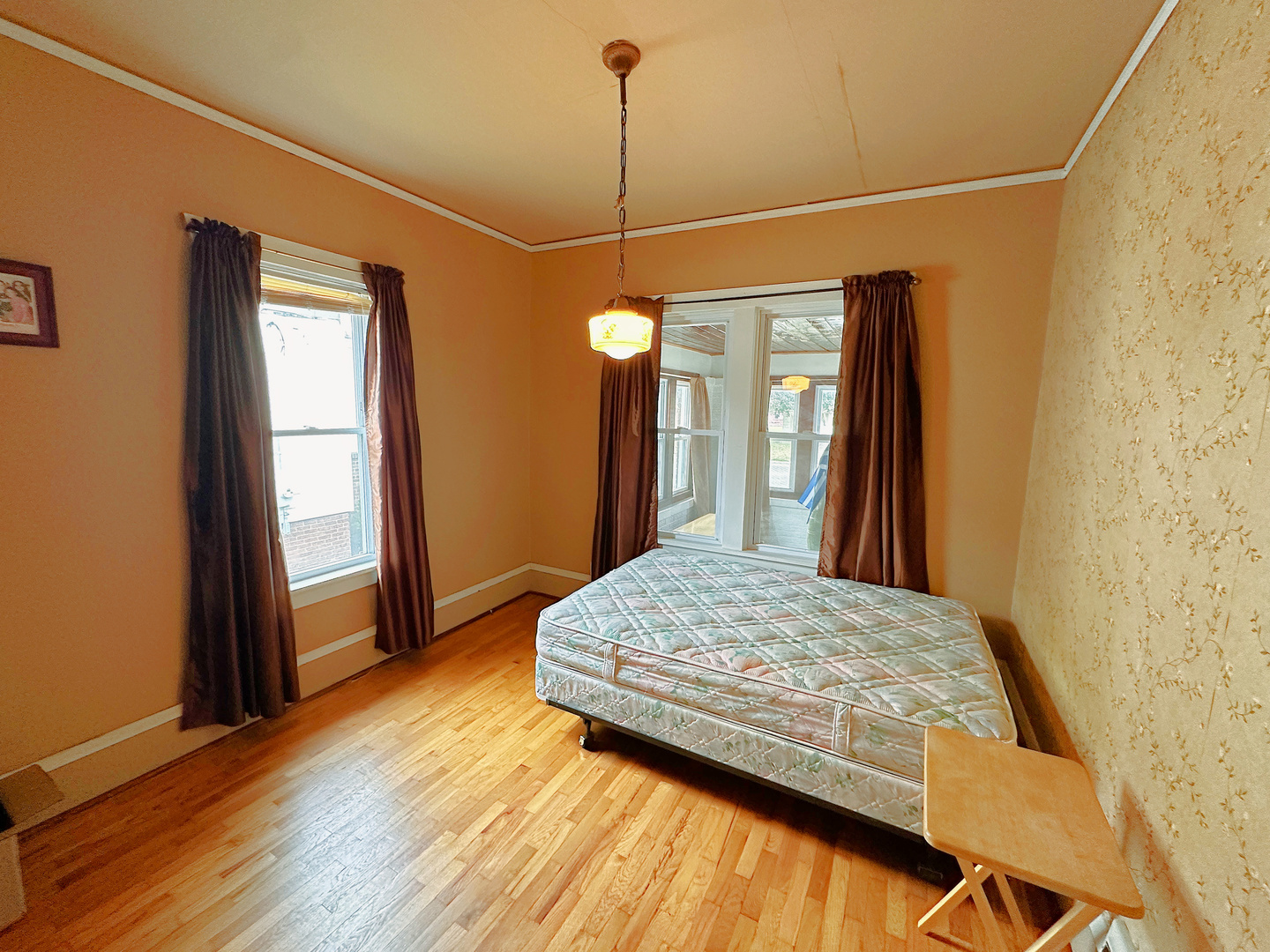 1121 East Main Street Streator, IL 61364 - Photo 10 of 22 a bedroom with a bed window and wooden floor