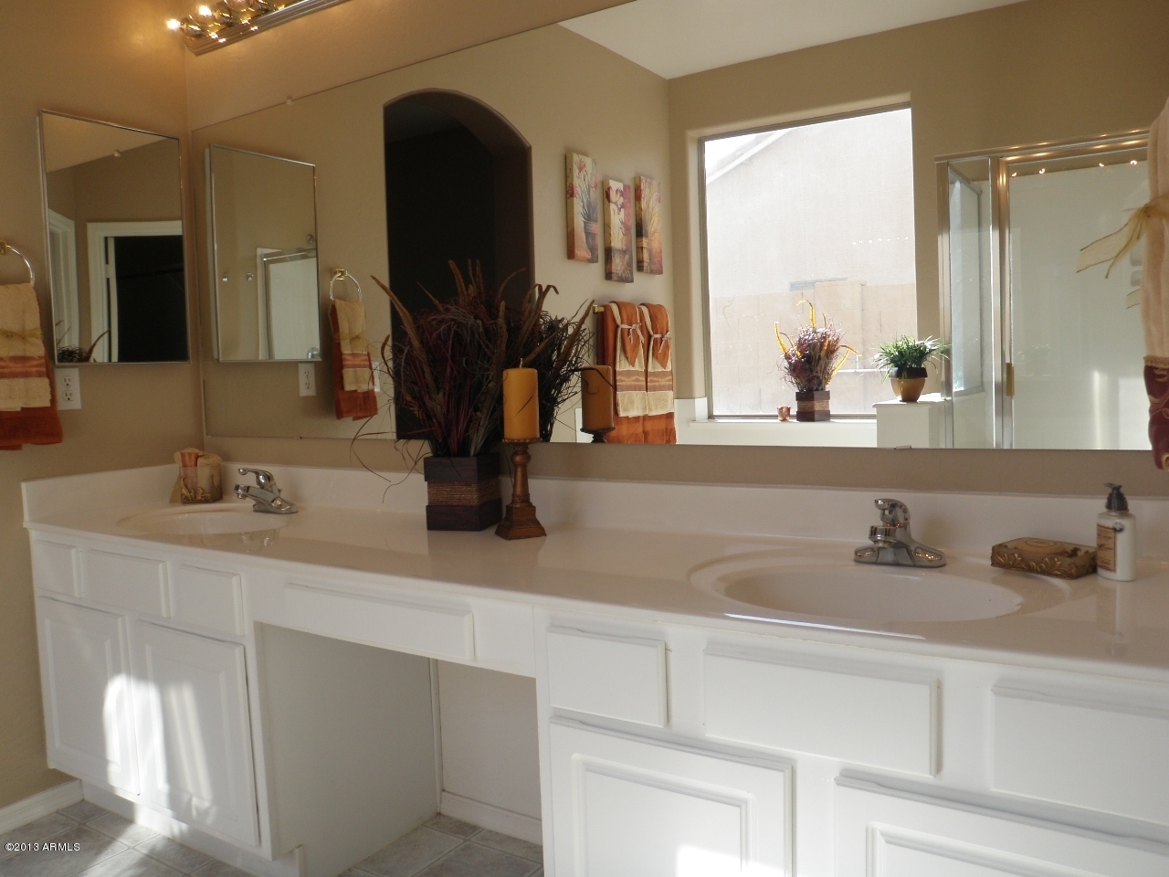 3672 South Martingale Road Gilbert, AZ 85297 - Photo 20 of 45 a bathroom with a double vanity sink and a mirror
