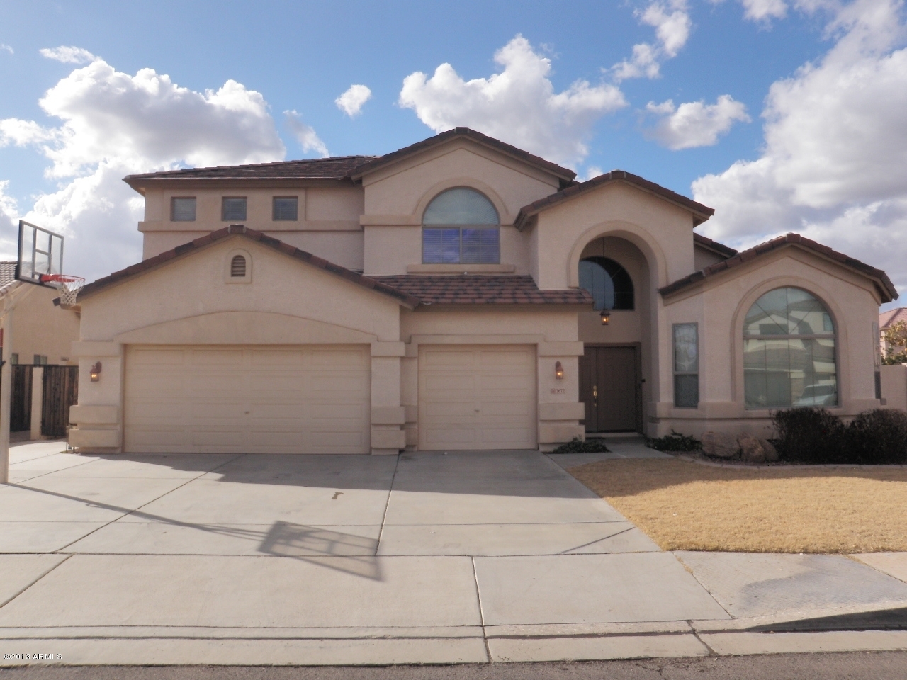 3672 South Martingale Road Gilbert, AZ 85297 - Photo 2 of 45 a front view of a house with a yard and garage