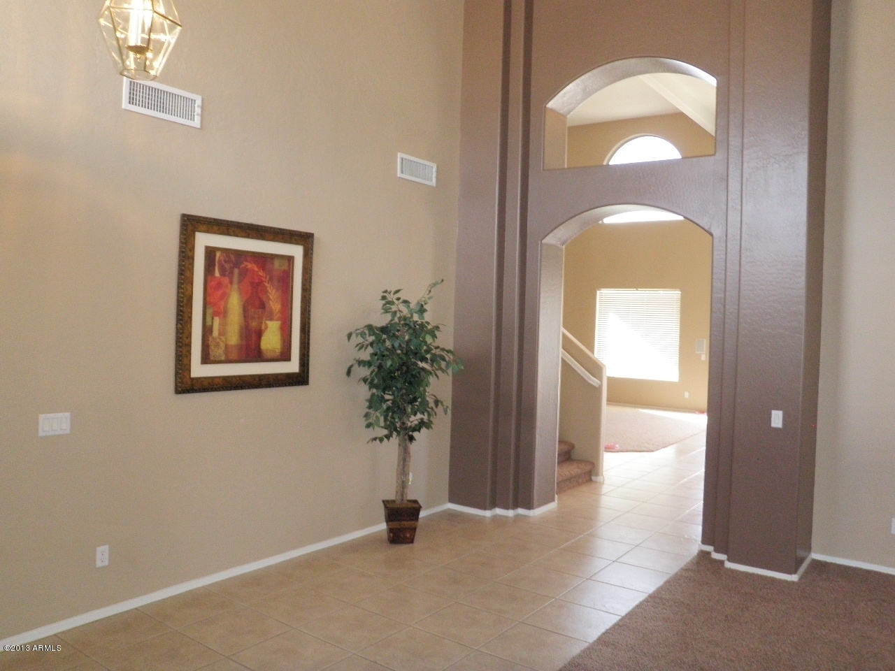 3672 South Martingale Road Gilbert, AZ 85297 - Photo 3 of 45 a view of a livingroom with a potted plant
