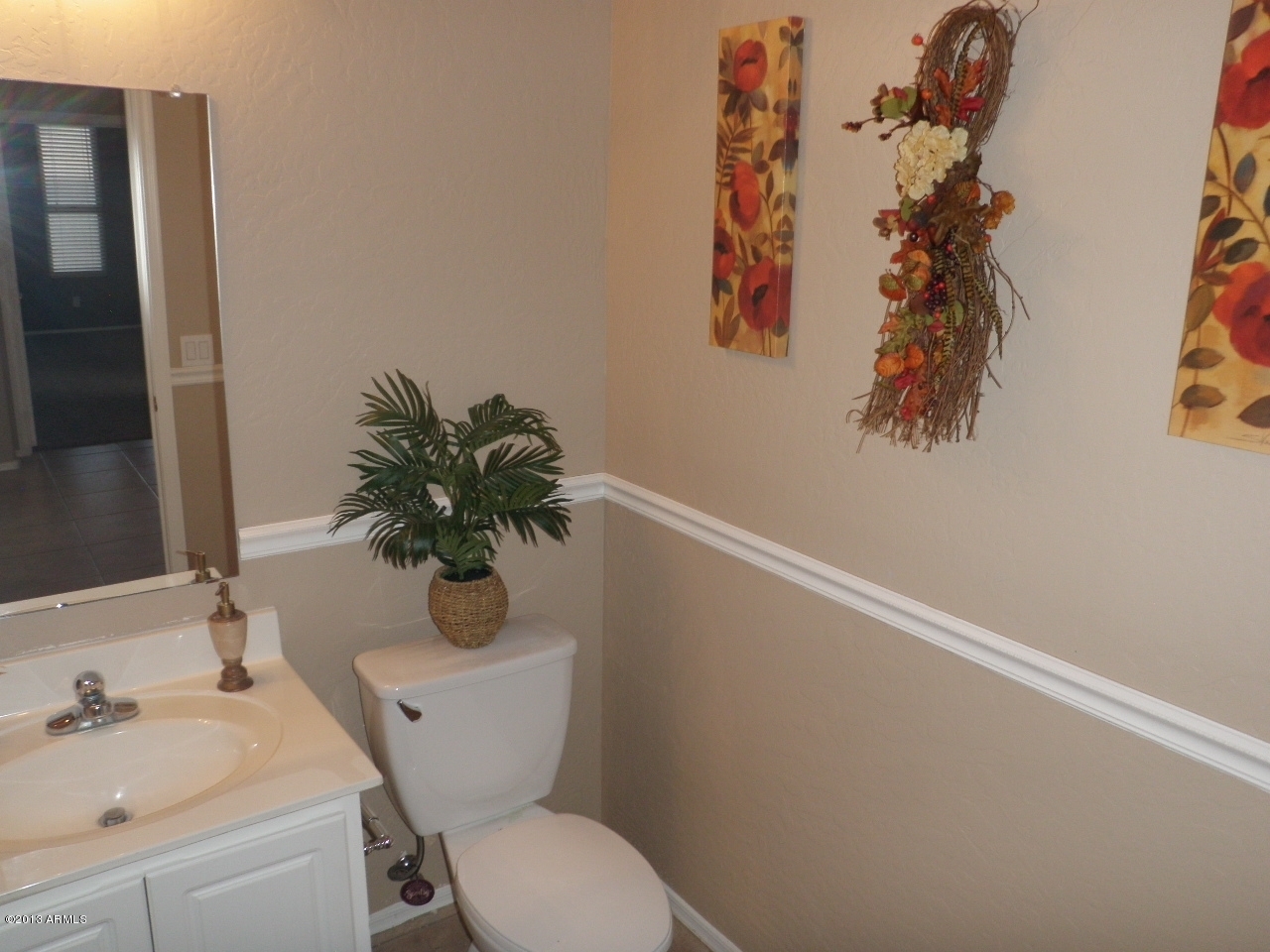 3672 South Martingale Road Gilbert, AZ 85297 - Photo 33 of 45 a bathroom with a toilet sink and mirror