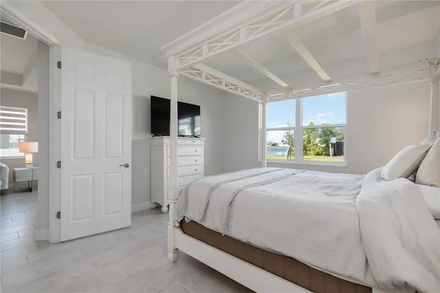 a bedroom with a bed and a television