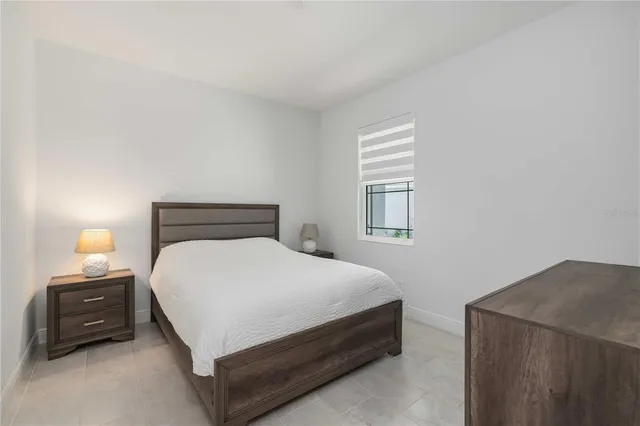 a bedroom with a bed and a tv