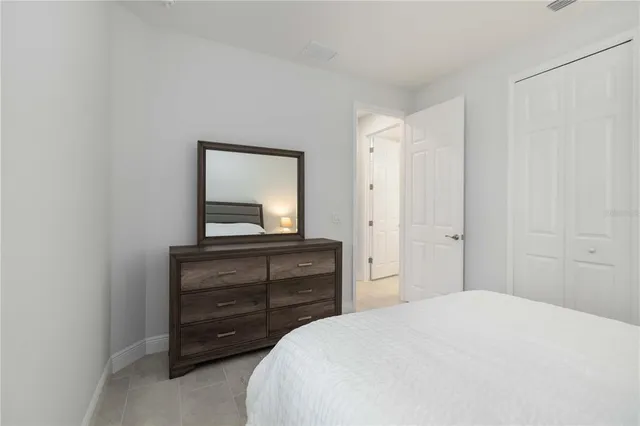 a bedroom with a bed and a dresser