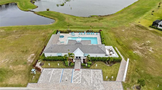 an aerial view of residential houses with outdoor space and swimming pool