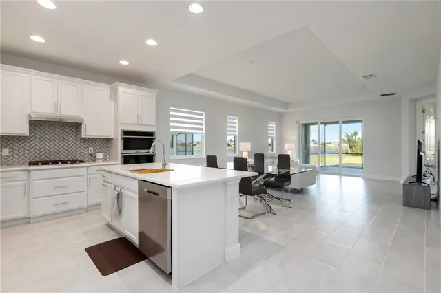 a kitchen with a sink cabinets and wooden floor