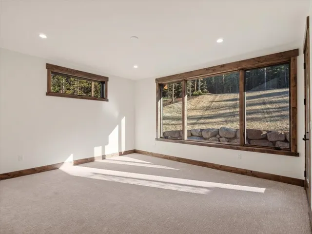a view of a big room with wooden floor and windows