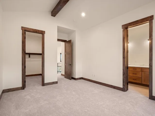 an empty room with closet and a bathroom