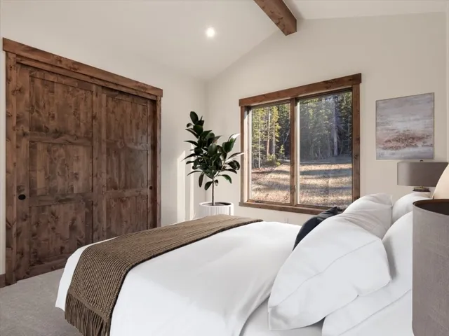 a bedroom with a large bed and a large window