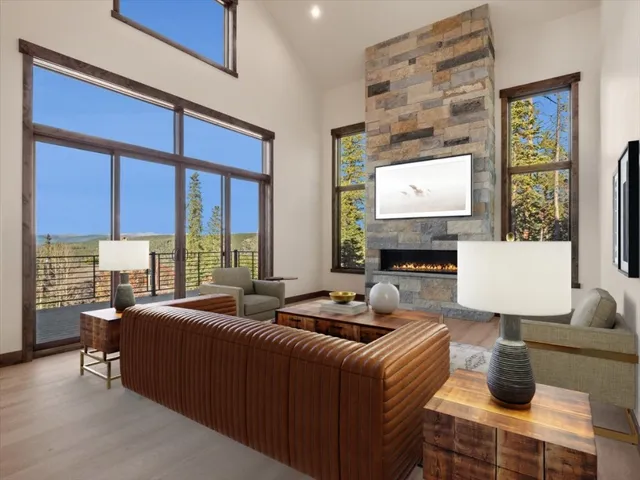 a living room with furniture a large window and a flat screen tv