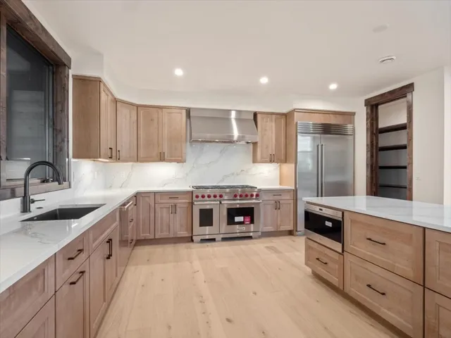 a kitchen with stainless steel appliances a stove sink and cabinets