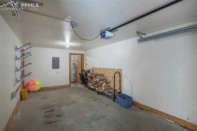 710 Gothic Road, Unit 1 Crested Butte, CO 81225 - Photo 8 of 25 Garage featuring a garage door opener and water heater